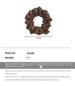 Close-up of leopard print suede scrunchie with handmade label and 10cm size detail