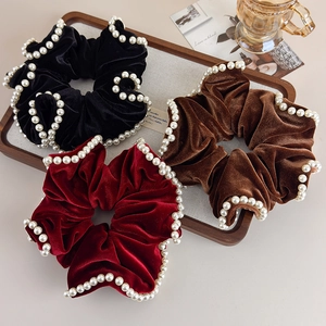 Three velvet scrunchies in black, red, and brown colors with elegant pearl edges