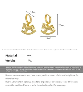Detailed view of golden rocking horse earrings with hammered texture and 2.5cm height
