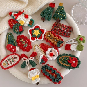 Detail showing a variety of handmade crochet Christmas hair clips with festive motifs