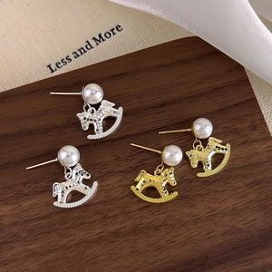 Elegant rocking horse earrings with pearls and hammered metal texture in gold and silver