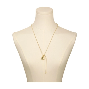 Golden money bag pendant necklace with dollar symbol on elegant mannequin display