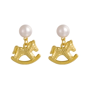 Elegant gold rocking horse earrings with pearls and hammered texture on white background