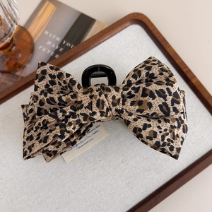 Elegant leopard print bow hair claw clip for thick hair styling in brown and black