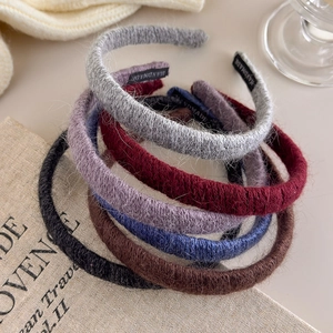 Set of six fuzzy knitted headbands in autumn colors including black, brown, and wine red