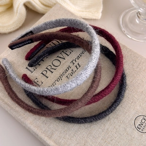 Detail of handmade knit headbands in grey and burgundy colors with soft wool texture