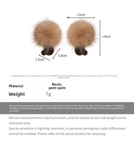 Detailed view of plush pompom earrings with resin base showing 3cm and 4cm dimensions
