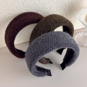 Three plush wide headbands in purple, brown, and grey with soft faux fur texture
