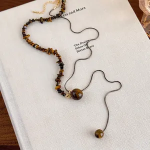 Irregular tiger eye beaded necklace with snake chain for vintage sweater styling
