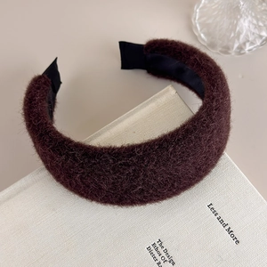 Detail showing the thick brown plush faux mink texture and inner black fabric lining