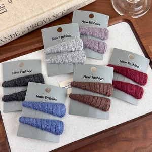 Winter knitted BB hair clips in 6 colors displayed on a vintage aesthetic wooden tray