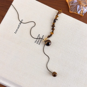 Detail of bohemian tiger eye stone necklace showing irregular beads and natural sheen