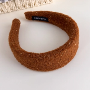 Detail of caramel plush headband with gold glitter and Hand Made fabric label