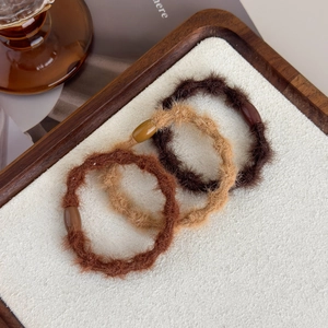 Three-piece set of plush elastic hair ties in warm earthy tones with resin beads