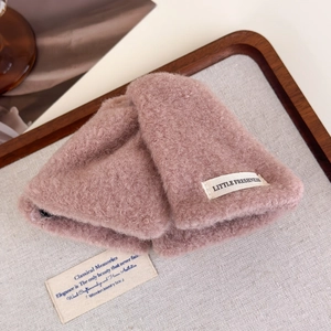 Detail of pink plush hand warmers featuring soft wool-like texture and Little Freshness tag