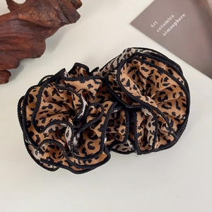 Detailed view of leopard print scrunchie featuring multi-layer ruffle chiffon design