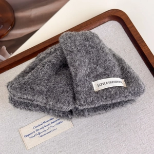Detail view of grey textured wool hair claw with Little Freshness woven label