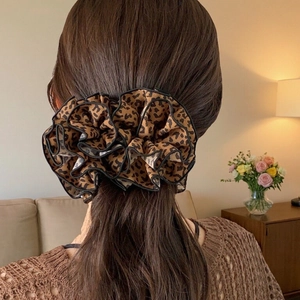 French vintage leopard print hair scrunchie shown on model in warm home setting