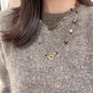 Double-layered tiger eye stone necklace with OT toggle clasp on a knit sweater