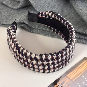 Detailopname van meerkleurige tweed hoofdband textuur met zwarte antislip voering
