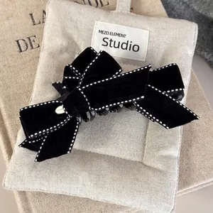 Elegant black velvet double bow hair clip with white stitching and gold metal buckle