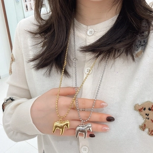 Elegant beaded chain necklace featuring gold and silver rocking horse pendants for women