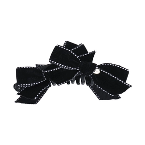 Elegant black velvet bow hair clip with white dotted edges and luxury gold detail