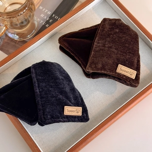 Vintage velvet triangular shark clips in black and dark coffee on a wooden tray