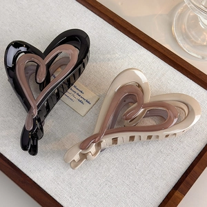Brown gradient heart hair claws with glossy resin finish in 45-degree angle view