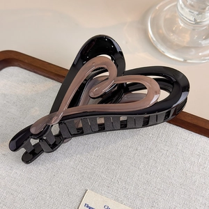 Close-up of a double-layered heart hair claw clip in elegant gradient coffee and black