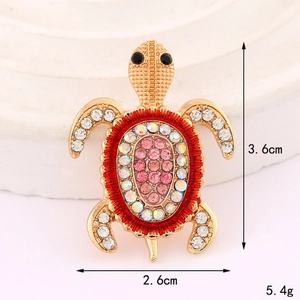 Sparkling turtle brooch with pink crystals and golden metal, 3.6cm by 2.6cm dimensions