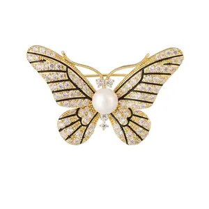 Exquisite golden butterfly brooch featuring shimmering crystals and a central white pearl