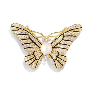Elegant gold butterfly brooch with zircon wings and a white pearl center on white background
