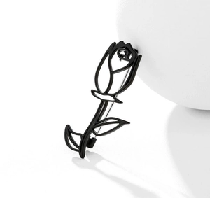 Detail of elegant black matte hollow rose brooch with artistic hollowed-out line design