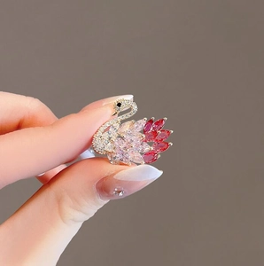 Elegant swan brooch with white diamonds and pink-red gradient marquise gemstones