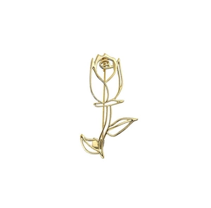 Macro detail of elegant gold hollow rose brooch with artistic minimalist metal outline