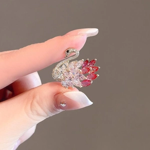Elegant swan brooch with pink and magenta gradient crystals on a gold-plated base