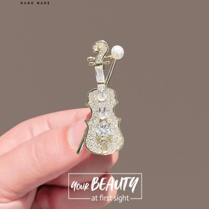 Elegant silver violin brooch with sparkling crystals and a white pearl accent