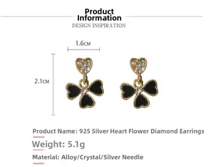 Macro view of 925 silver heart and clover earrings with rhinestones measuring 1.6x2.1cm