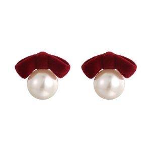 Elegant pearl earrings with deep red velvet bows for a vintage autumn and winter fashion look