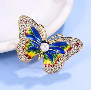 Luxury butterfly brooch with enamel wings, white crystals, and pearl in gold setting