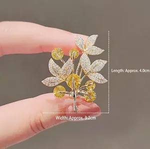 Elegant silver tree brooch with yellow and white crystals for autumn winter coats