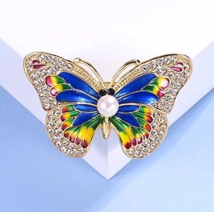 Luxury butterfly brooch with colorful enamel wings, sparkling rhinestones and a white pearl