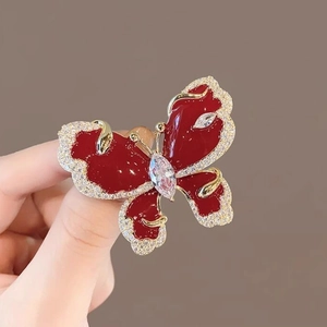 Elegant red butterfly brooch with sparkling crystals and gold finish for women's fashion