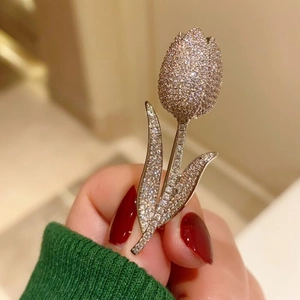 Detailed view of hand-held tulip brooch with sparkling pavé cubic zirconia inlay