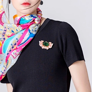 Retro chinese style flower brooch with green stone and pink petals on silk scarf