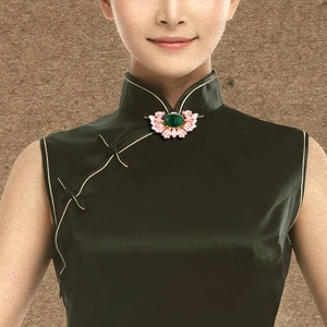 Chinese style retro floral brooch with green gemstone on a black cheongsam collar