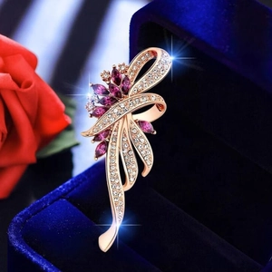 Elegant gold flower brooch with magenta marquise stones and white crystal accents