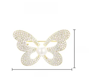 Vue détaillée de la broche papillon avec cristaux, perle et dimensions de l'article