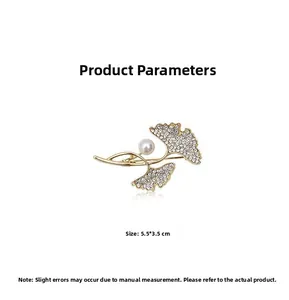Detail view of a golden ginkgo leaf brooch with pearls and crystals measuring 5.5 by 3.5 cm